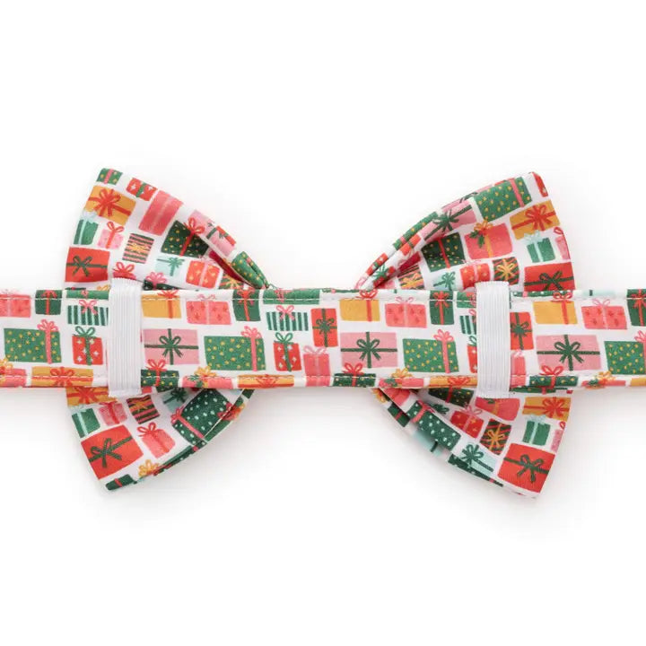 Christmas-themed bow tie with colorful gift box pattern on a white background