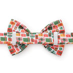 Christmas-themed bow tie with colorful gift box pattern on a white background