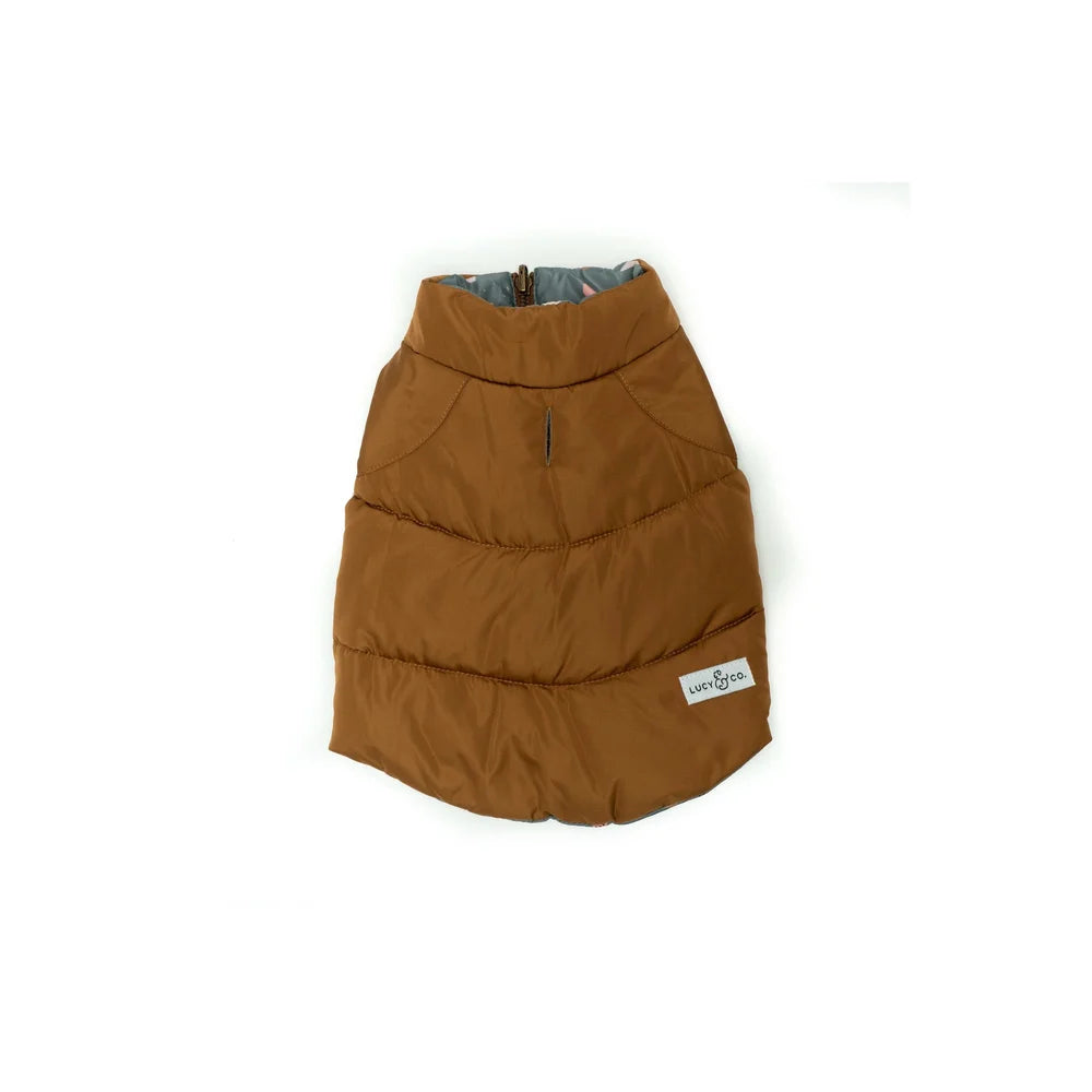 Brown puffer dog vest with a visible brand label on a white background