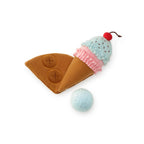Toy resembling an ice cream cone with a cherry on top and a ball, on a white background