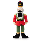 Plush dog toy in the shape of a nutcracker soldier on a white background