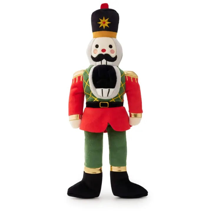 Plush dog toy in the shape of a nutcracker soldier on a white background