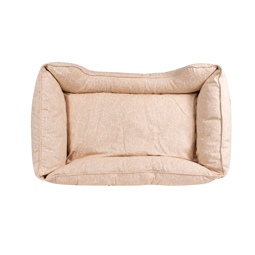 Beige dog kuddler bed with floral pattern on a white background