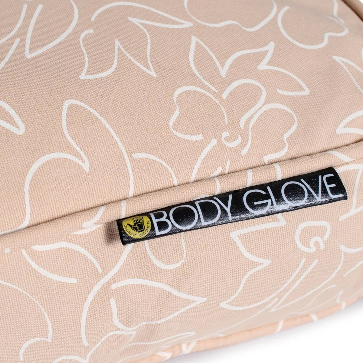Beige dog bed with white floral patterns and 'Body Glove' label.