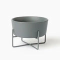 Gray dog food or water dish with metal stand on a white background