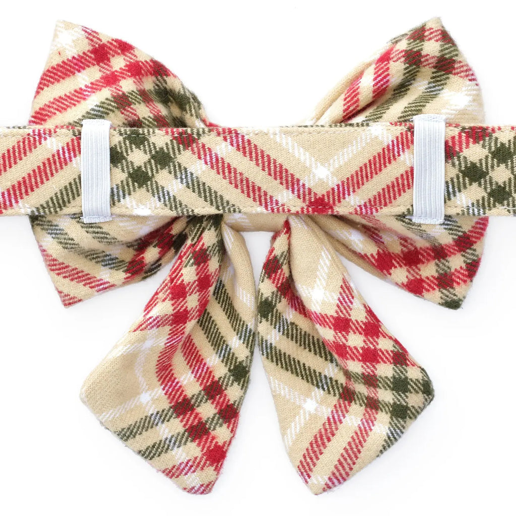Plaid bow tie with red, green, and beige colors on a white background
