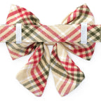 Plaid bow tie with red, green, and beige colors on a white background