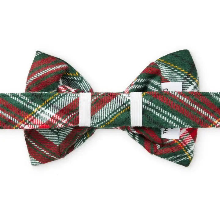 Plaid bow tie with red, green, and white pattern on a white background