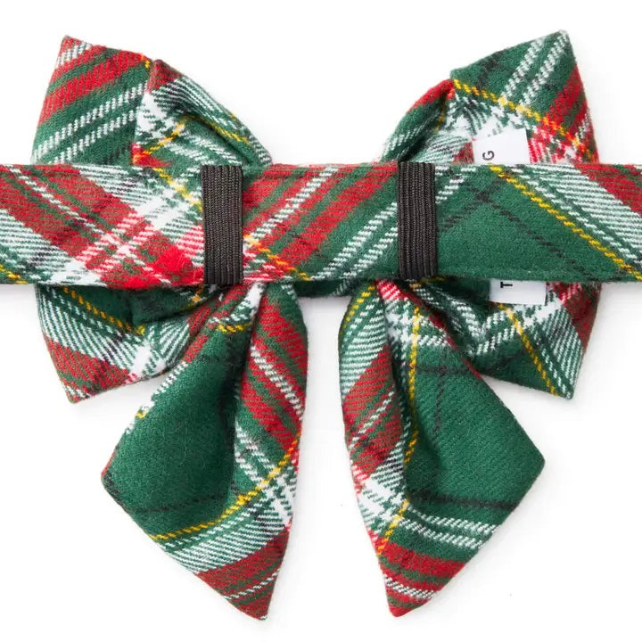 Plaid bow tie with red, green, and white pattern on a white background