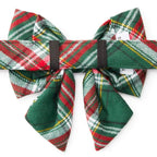 Plaid bow tie with red, green, and white pattern on a white background
