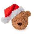Plush bear dog toy wearing a Santa hat on a white background