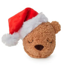Plush bear dog toy wearing a Santa hat on a white background