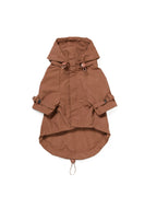 Underside of brown dog raincoat with a hood on a white background